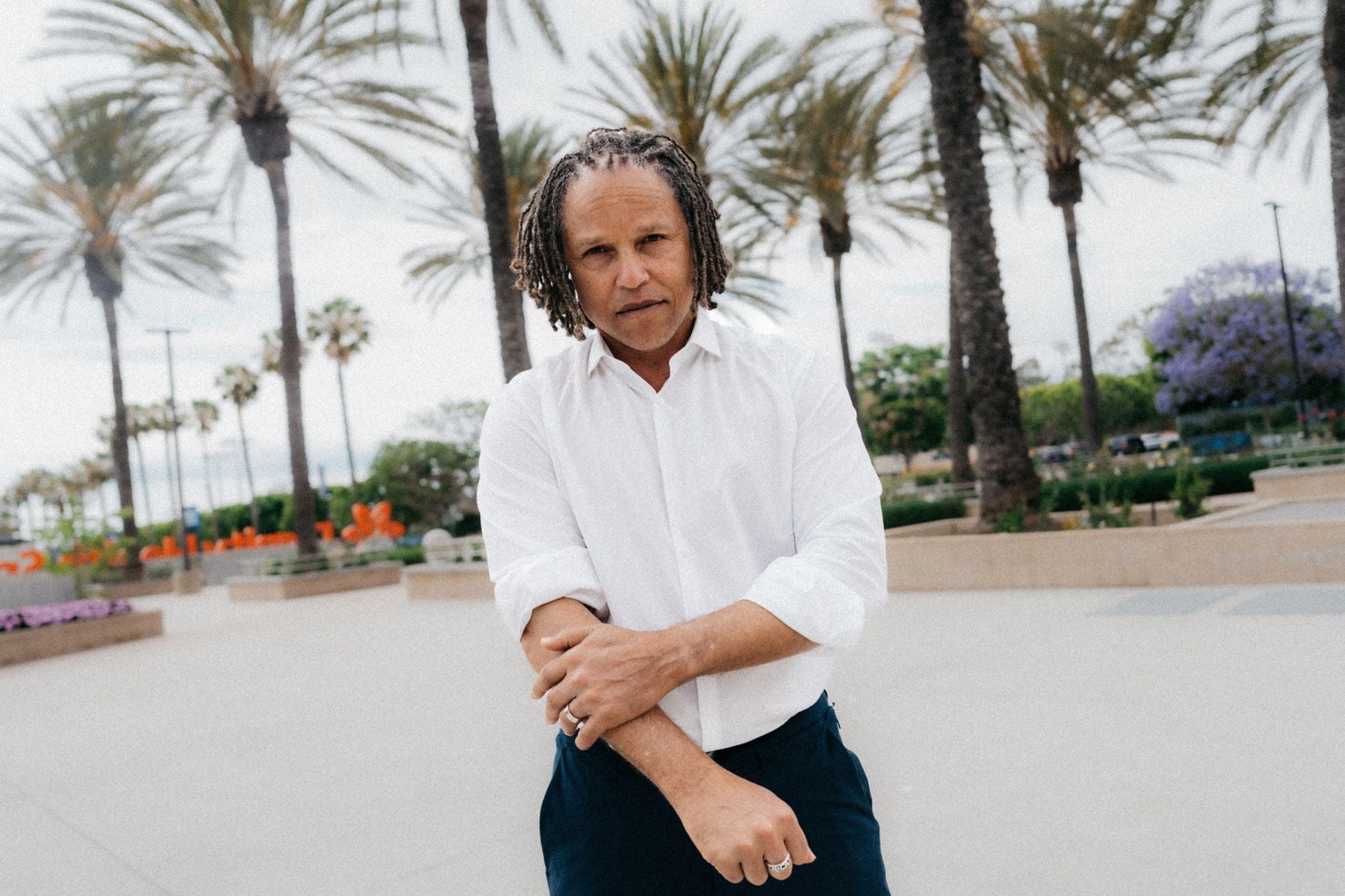 Cobi Jones in a white button-up shirt and slacks standing on the grounds of Dignity Health Sports Park